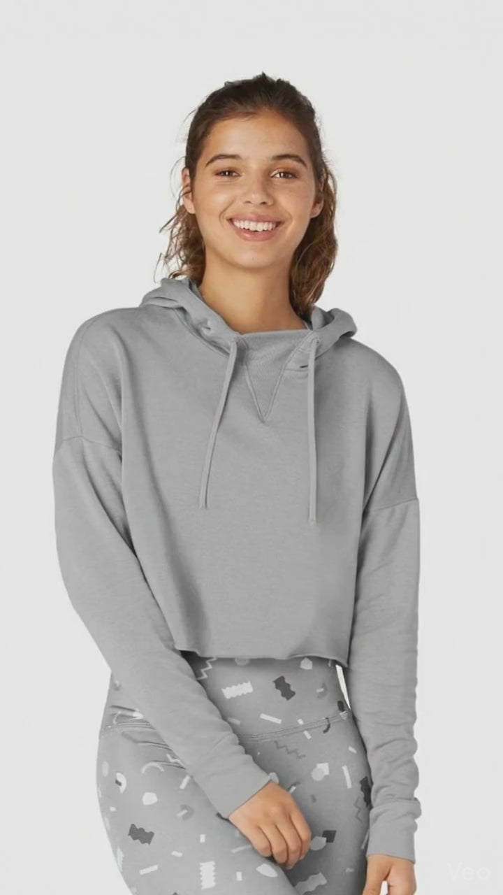 Woman wearing a gray hoodie with a white background