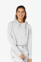 Woman wearing a light gray hoodie with a white background