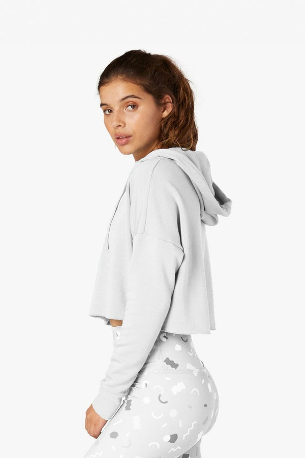 Woman wearing a light gray hoodie with a white background